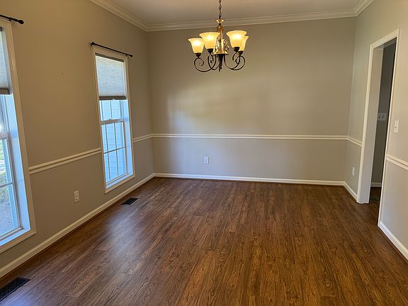 The Dining Room features chair rail and crown moldings, and is located on the front of the home off of the entry and Kitchen areas