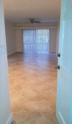 View front door through kitchen and living/dining area. 8 ft sliders.