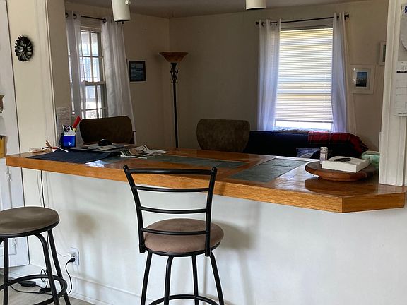 Eat in kitchen counter with bar stools in kitchen and living room