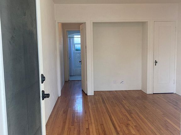 Living room with alcove and storage closet.