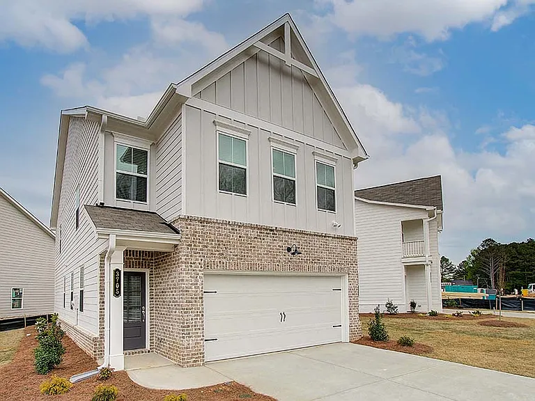 Exterior of the Florance, two story home with a private driveway and attached garage.