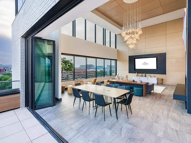 Host guests or unwind solo in the indoor-outdoor lounge with dramatic ceilings, city views, and comfortable seating areas.