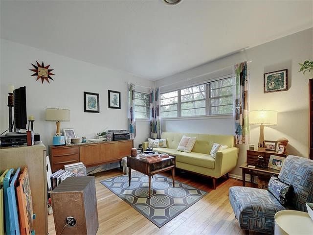 Large living room with hard wood floors. It has a separate