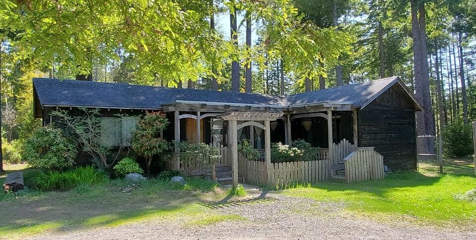 Front view of home with lovely garden area.