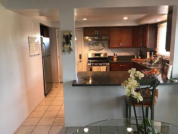 Nice size kitchen with window, granite counter tops, cherrywood cabinets, stainless steel appliances, and breakfast bar.