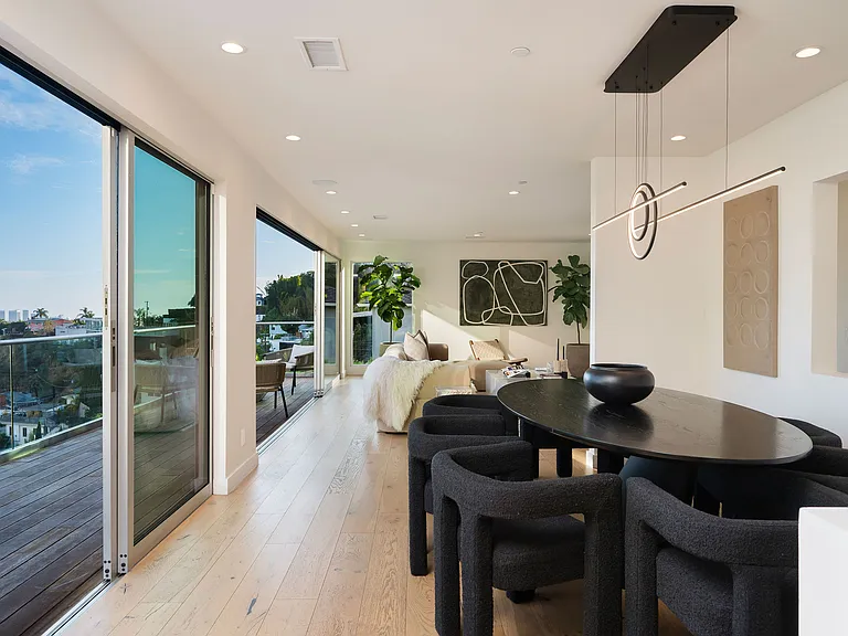 Grand open-concept living room with floor-to-ceiling glass walls.