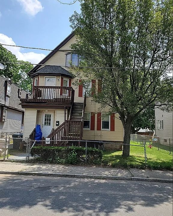 Front of property. Fully fenced. Stairs that go to second floor door actually leads up to 3rd floor (APT2).