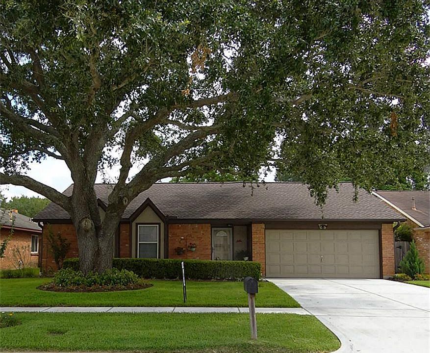 Regal oak graces the front yard of this beautiful home