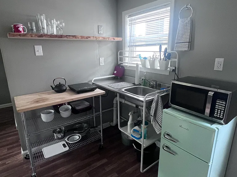 Kitchen with hot pad. Furnished with everything you'll need and basic cleaning supplies.