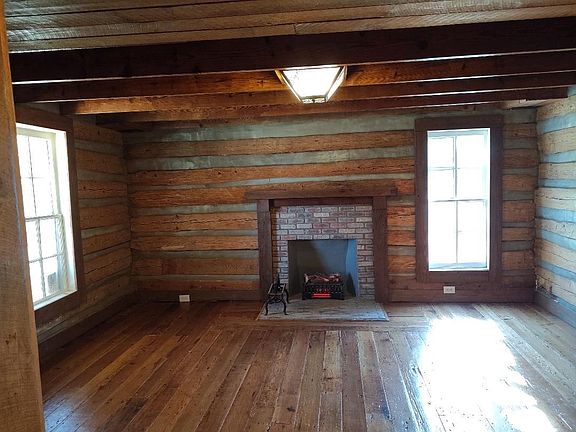 Log cabin Living Room! The fire place comes with decorative electric logs that produce heat and flickering light!
