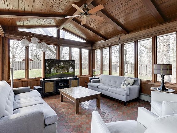 Check out this four season porch with a brick accent feature, three walls of windows overlooking the privately fenced back yard and a cathedral ceiling adding to the open feeling of the outdoors year round.