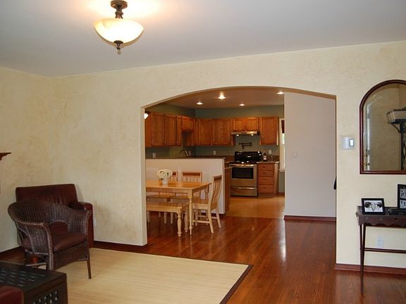 Walk through the door and you are welcomed by hand crafted Tuscany walls, refinished original hardwoods, original refinished floor, door and window trim. This large living room has a refurbished mahogany mantle and slate tile. Open floor plan invites you into the dining room and kitchen through the custom arch. Stairway to upper level is to the right behind the mirror.