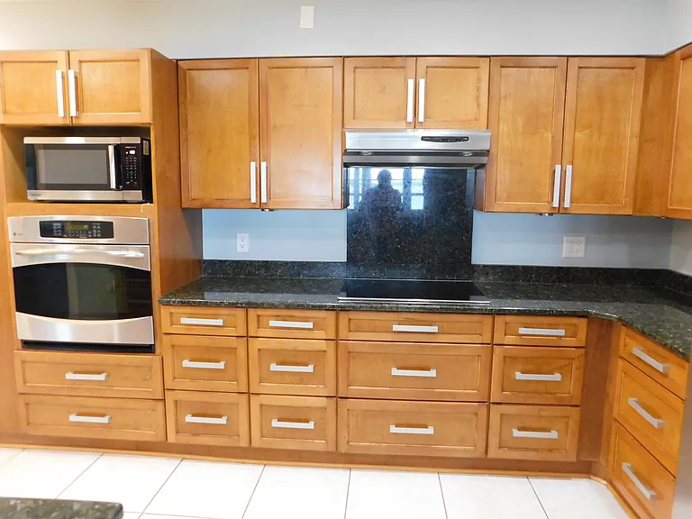 Here's another view of the oven, microwave & cooktop, looking eastward. On the other side of the wall is the living room.