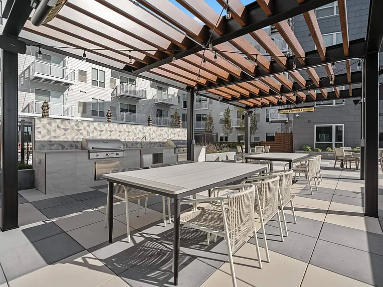 Shaded grilling pavilion & outdoor dining on the rooftop amenity deck at The Hallon Luxury Apartments in Hopkins MN