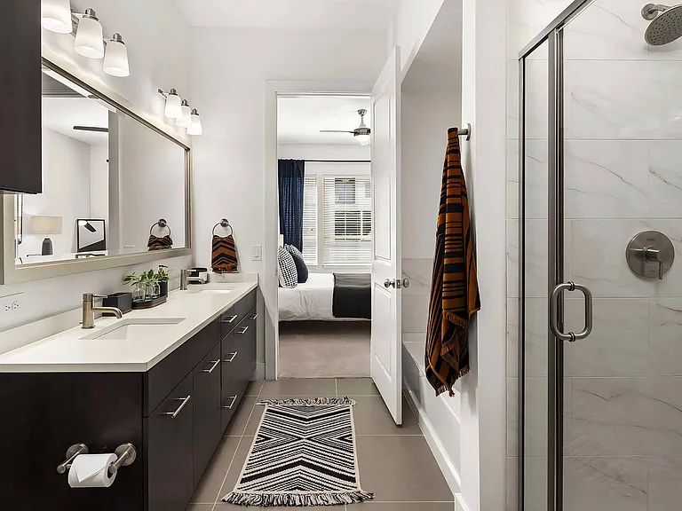 Ensuite Bathroom Featuring Dual Vanities and Glass Walk-In Shower