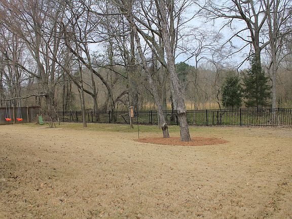 Large backyard, Wood Privacy Fence on Sides & Iron Waist Fence in Back
