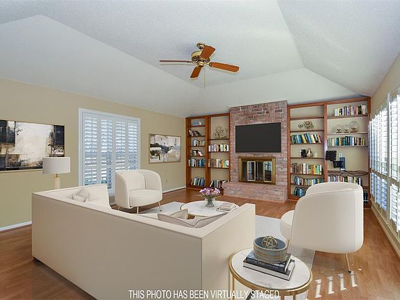 A wall of windows overlooking a sizeable deck allows plenty of natural light into the room. Vinyl wood flooring, gaslog fireplace flanked by plenty of shelving to display your treasure and a tray ceiling complete the room you will spend most of your 
