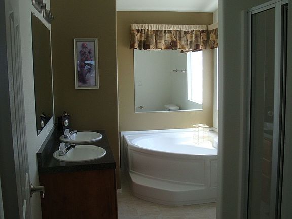 Master bath has double sinks, soaking tub, separate shower, glass block window