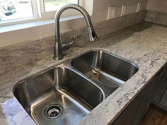 Faucet has beautiful granite counter tops and pull out faucet.