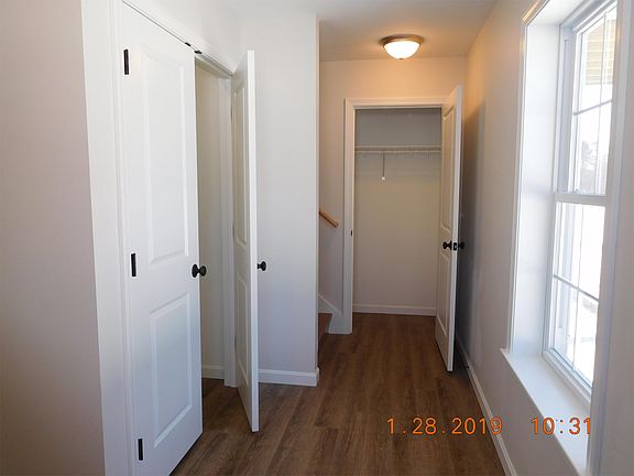 Private entryway with coat closet and washer dryer hookup closet.