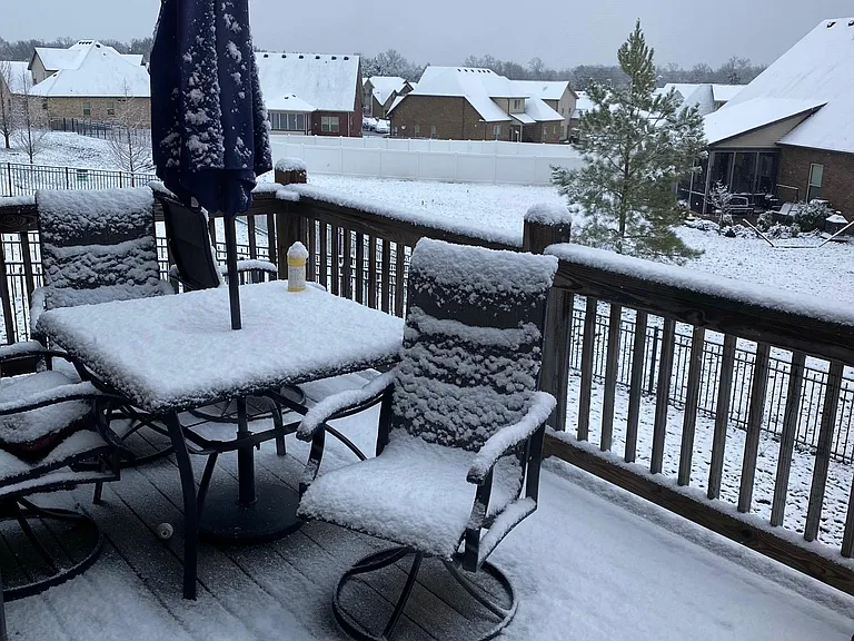 Back deck with fence seen in background. Space for a grill to the left just out of the picture
