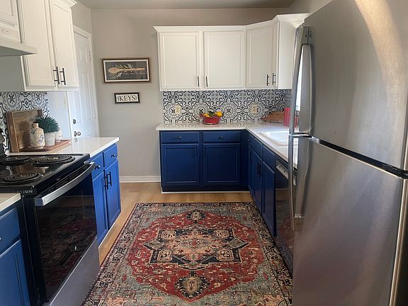 Kitchen with quartz counterto, luxury vinyl floors, new dishwasher, luxury vinyl floors, new widows, stove, dishwasher and stainless refrigerator.