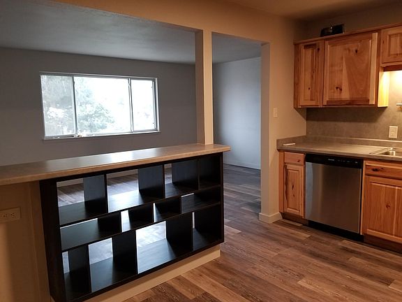 Looking into living room. Pleated shades & drapes in living room.