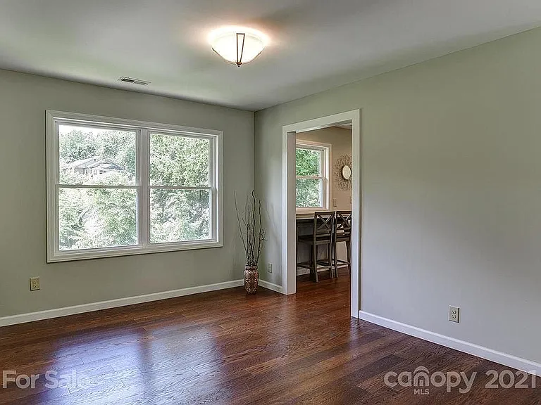 Sunny and bright dining area with pass to kitchen.