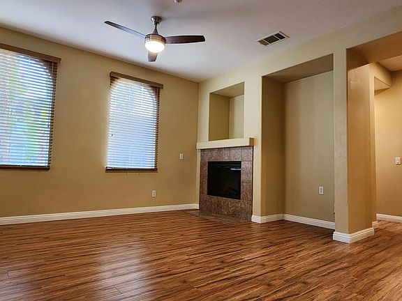 Living Room with Ceiling Fan and Fireplace