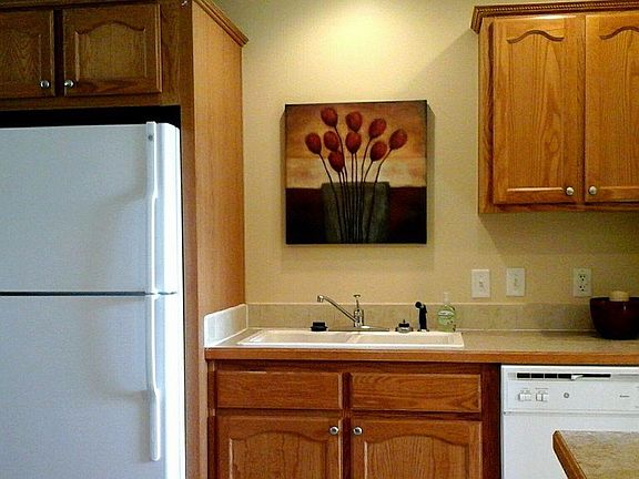Our kitchen features a refrigerator with an ice maker in the