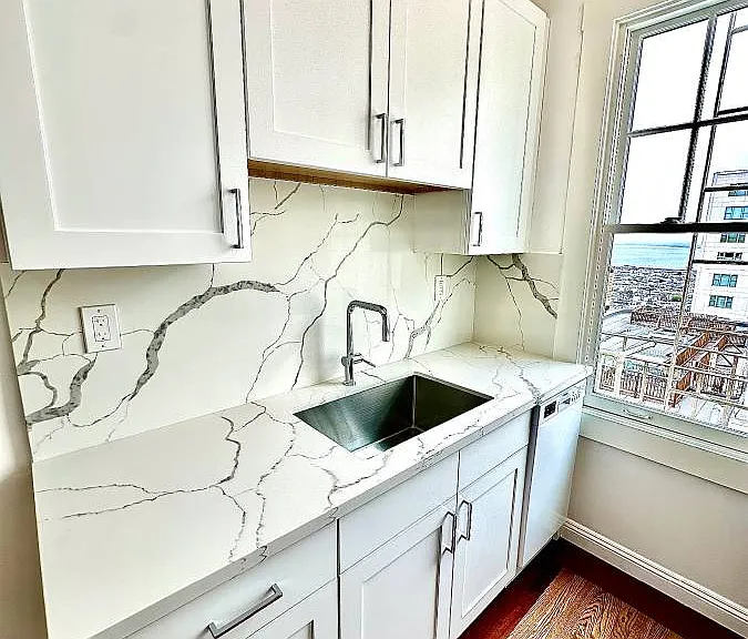Unit #602 remodeled kitchen with custom cabinetry and gorgeous quartzite countertops!