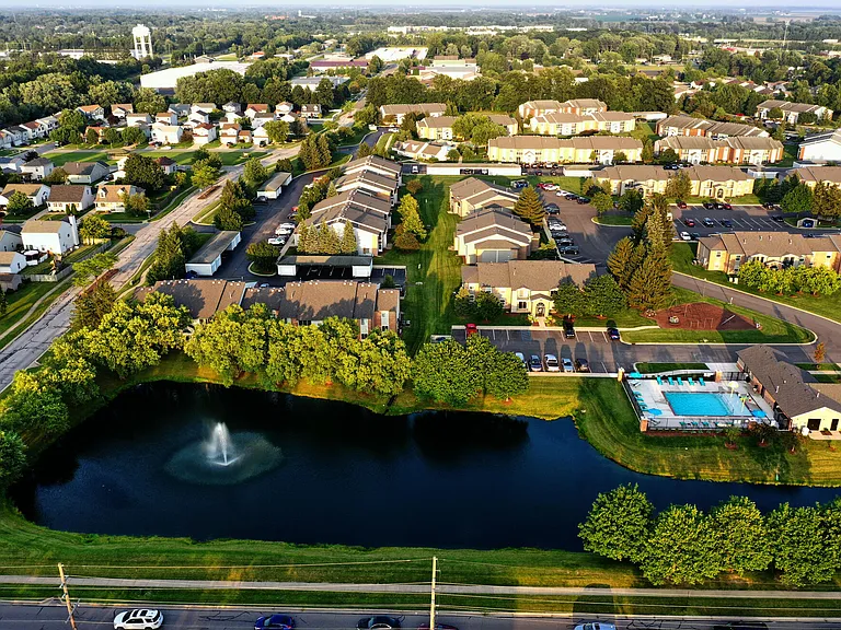 Aerial view of Compass Pointe featuring scenic ponds & sparkling pools.