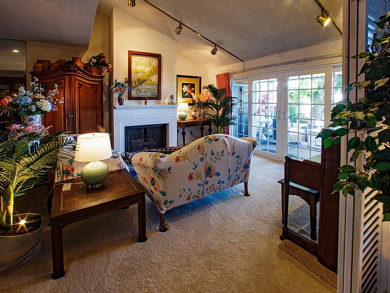 View from the Tv entertainment room to the living room. Check out the French doors that open to the amazing patio.