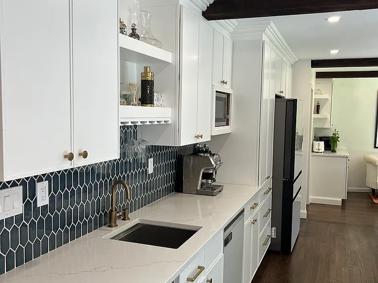 View of the kitchen bar, second sink and dishwasher.
