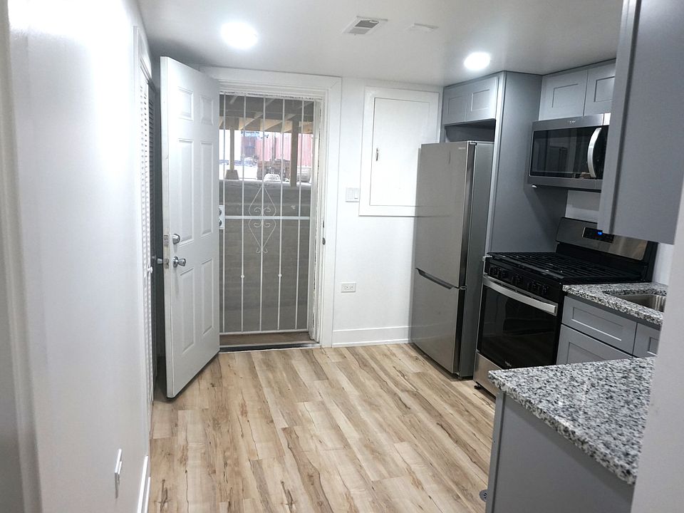 Kitchen with back door open that has a metal screen door