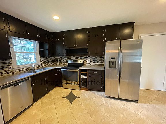 Kitchen features stainless steel appliances, L.E.D. can lights and L.E.D. under cabinet lights