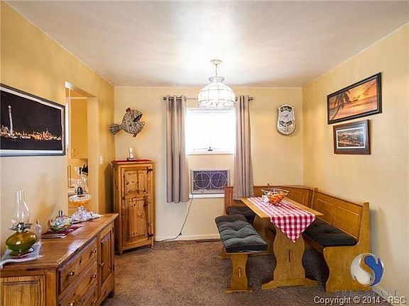 Dining area off he kitchen, evaporative cooler in the window tha