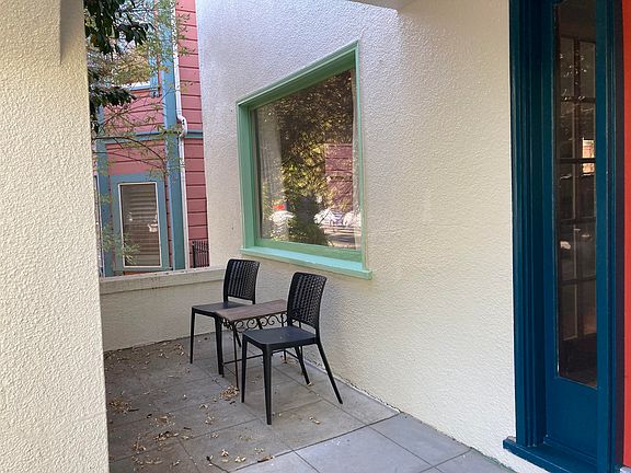 This is front porch area for the apartment. There is a large Camelia bush which acts as a privacy scree from people walking by.
