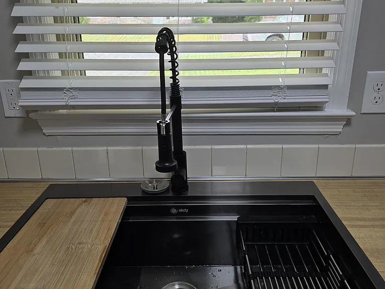 New sink and faucet - note cutting board and drainage basket.