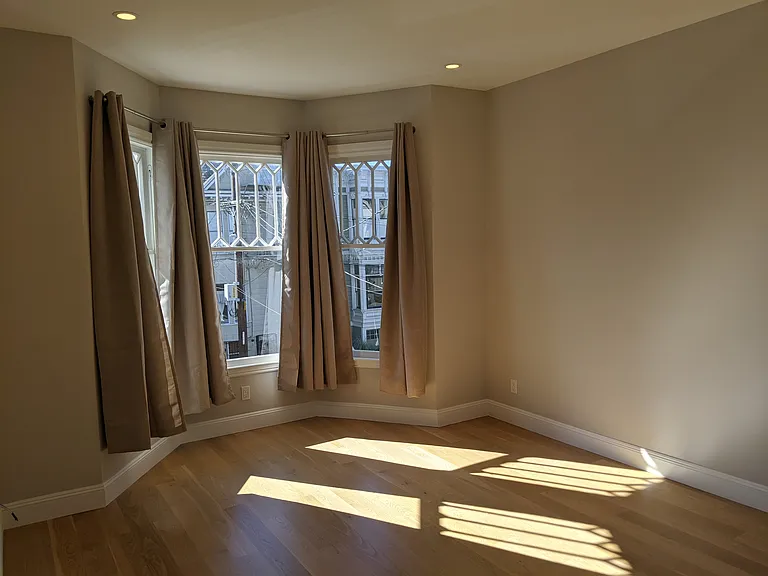 large sun-filled bedroom at the front of the unit