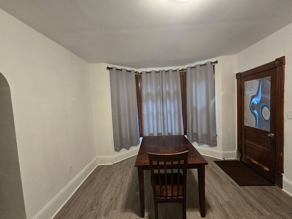 Dinning Room with three big windows and the entrance door