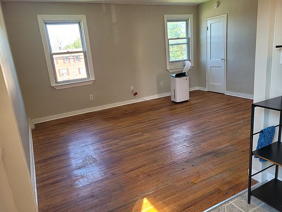 Living Room with hardwood floors and 1 portable window A/C unit