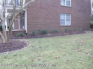 End unit First Floor condo all brick with big side yard buffer