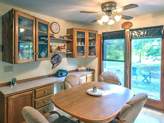 Glass front cabinetry in addition to additional cabinetry and counter space plus sliding glass doors to a large deck are perfect for family gatherings or backyard barbecues.