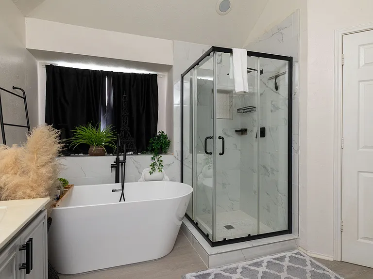 Spa-like master bath with freestanding tub and glass shower.