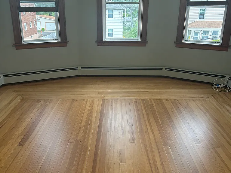 living room with hardwood floors and large bright widows