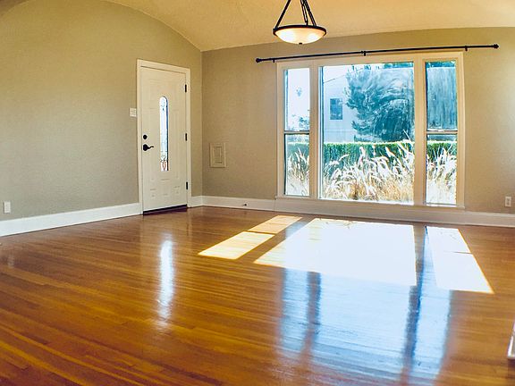 Another view of the Living Room out to ficus-hedged yard.