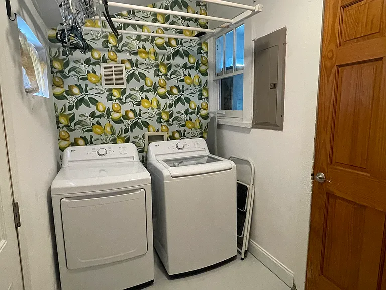 Washer and dryer in laundry room with extra pantry
