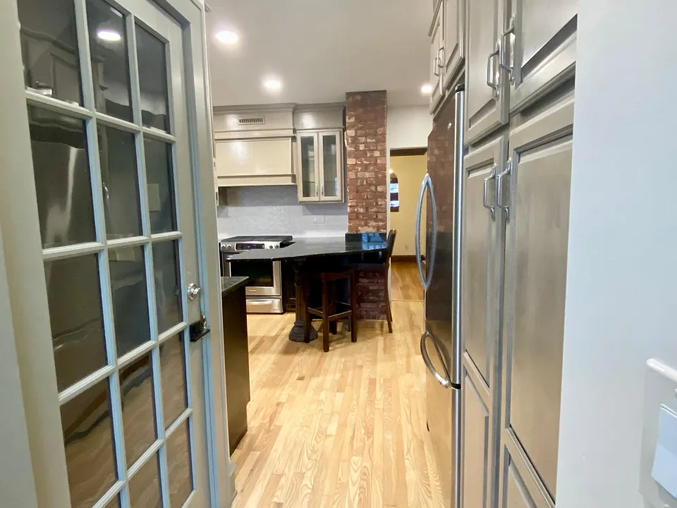 Custom cabinetry with full pantry for storage