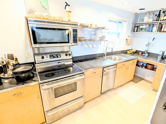 Kitchen updated with new dishwasher and flooring.